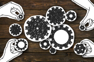 A Systems Thinking Approach to Improving Emergency Communications Paper hands collecting gears, creating whole mechanism