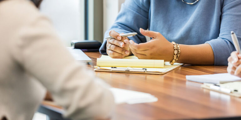 Women of different ethnicities participate in a group therapy session, sharing experiences and offering support.