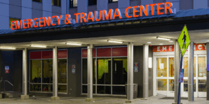 Seattle - July 09, 2022; Emergency and Trauma Center sign illuminated at Harborview Medical Center in Seattle over the entrance